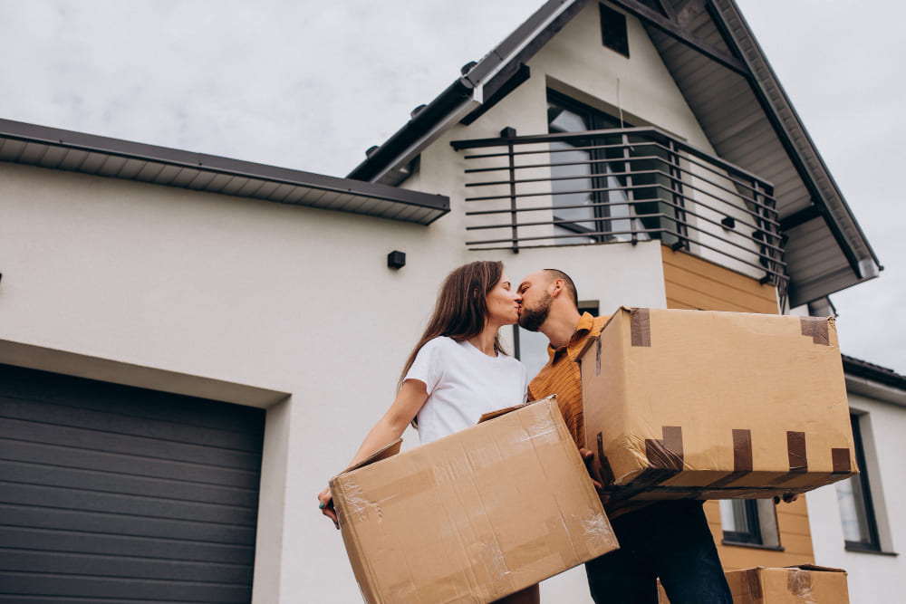 couple with boxes moving